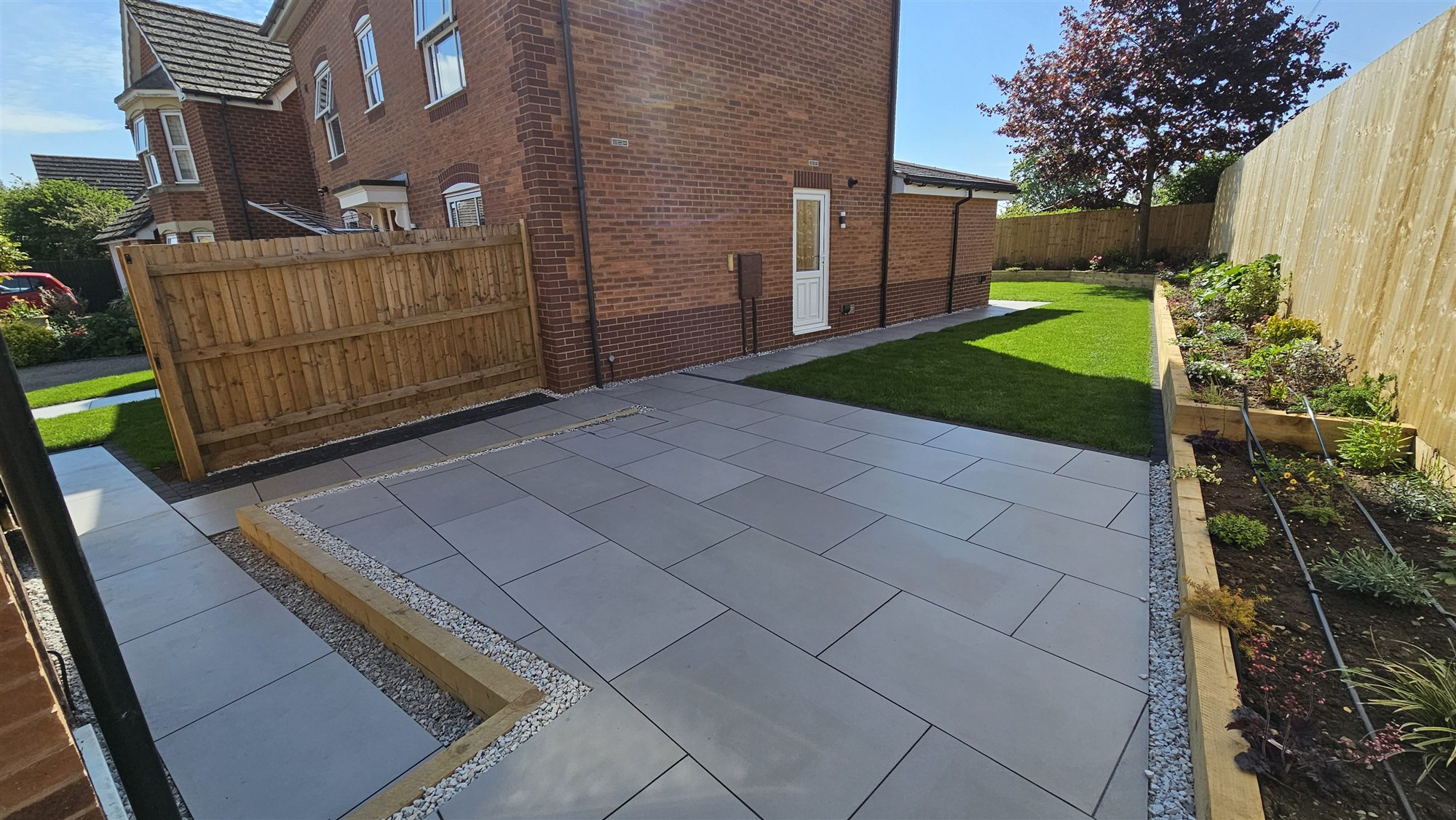 Oakham side garden with porcelain patio, turf and raised bed after transformation