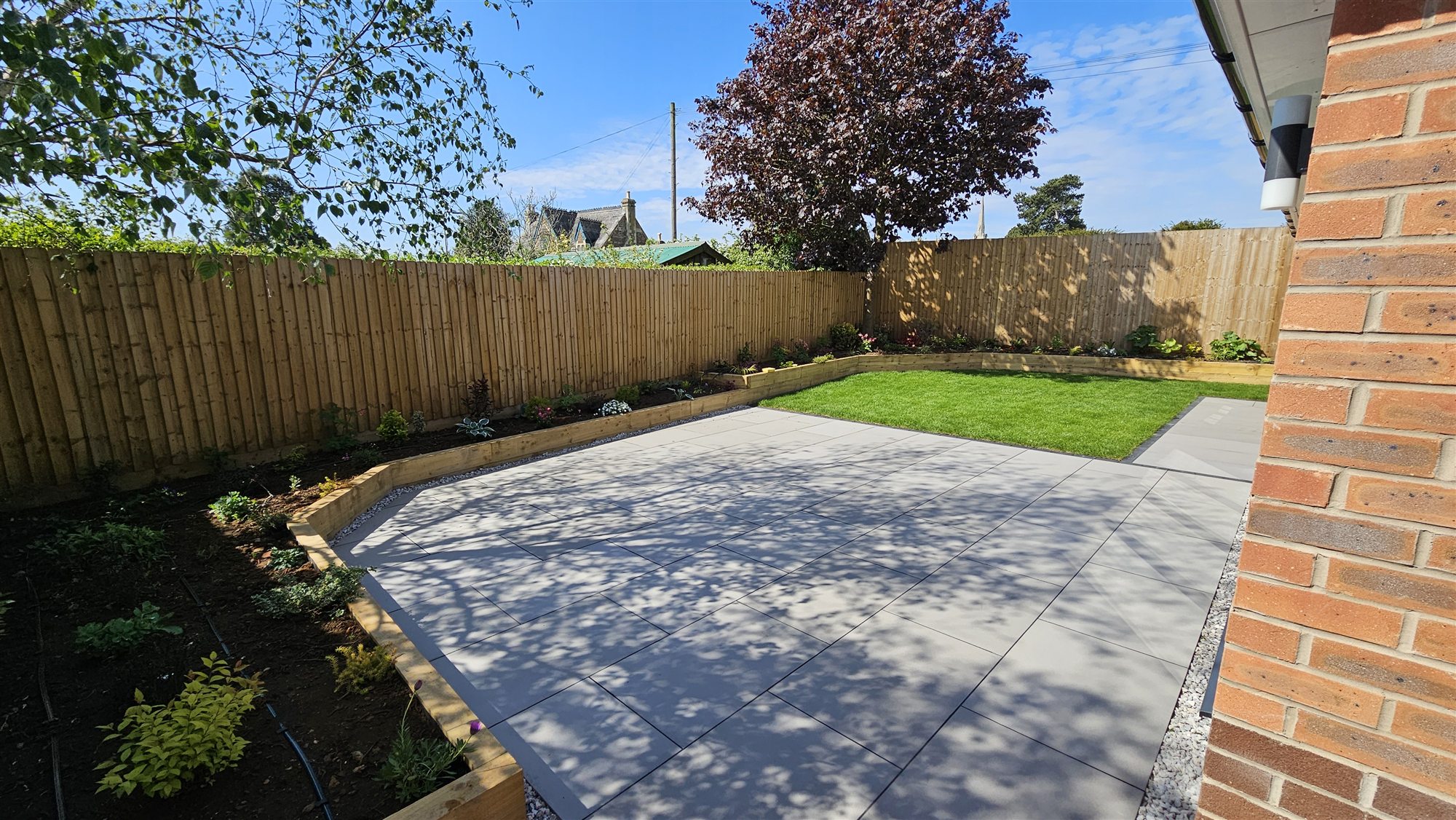 Existing Oakham garden terrace and lawn before transformation