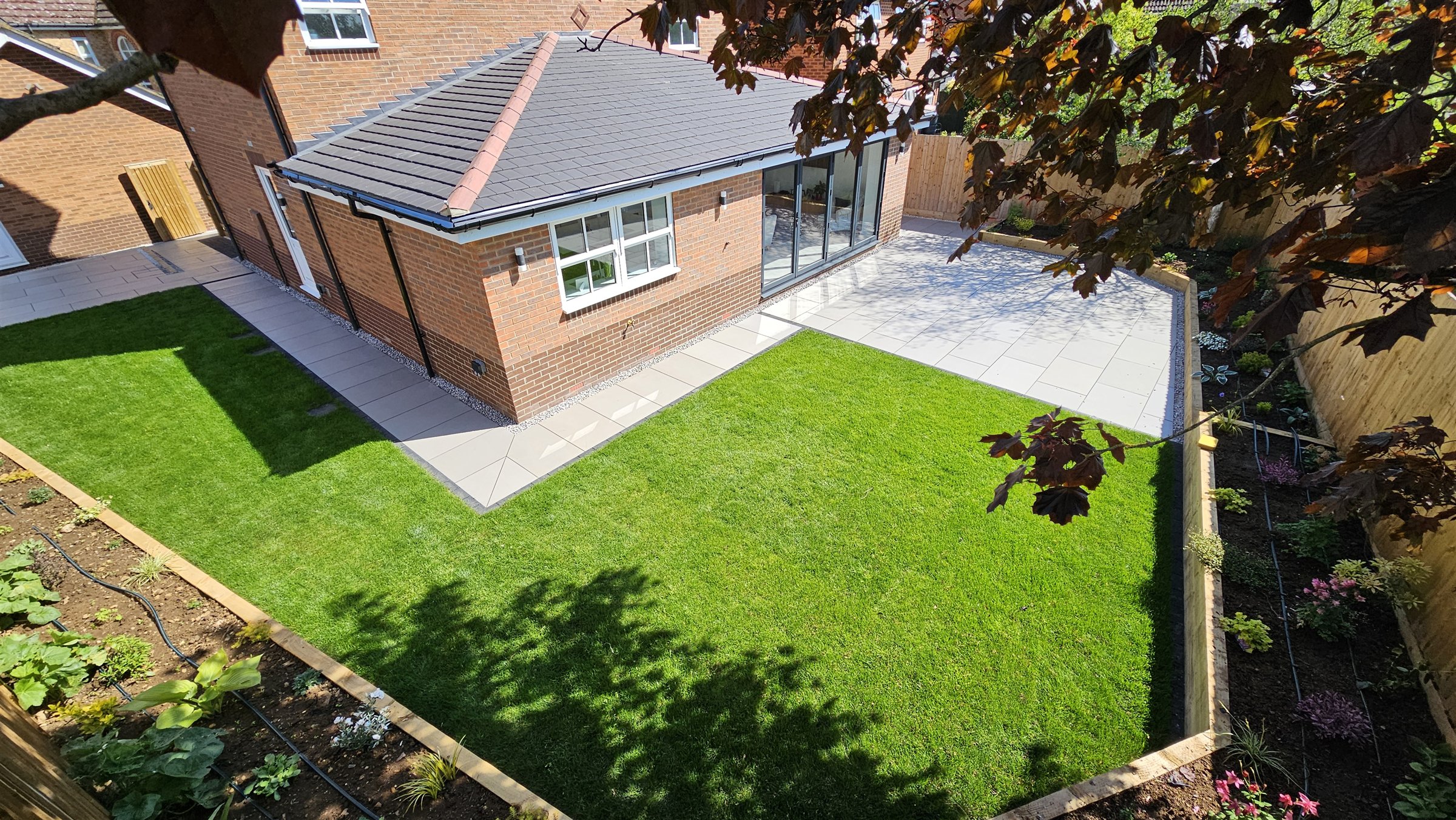Completed Instant Eden garden transformation in Oakham with porcelain paving, lawn and planting
