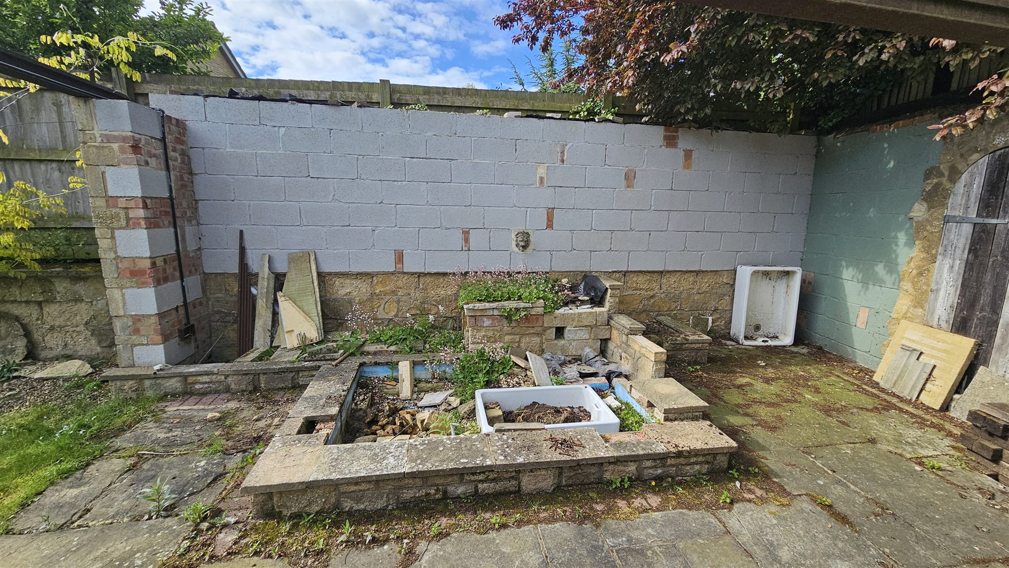 Disused wall and planting area before landscaping